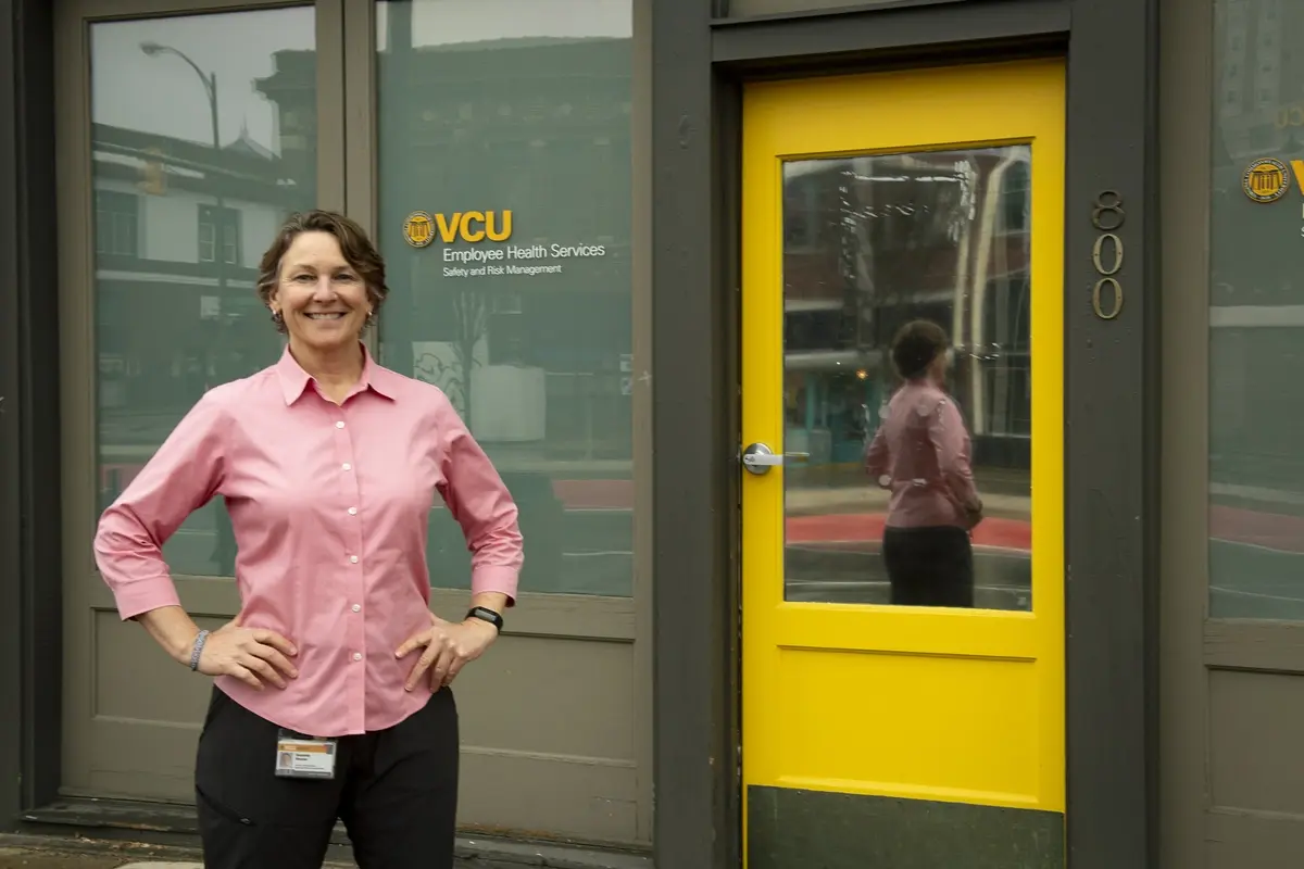 Woman standing in front of the Employee Health building